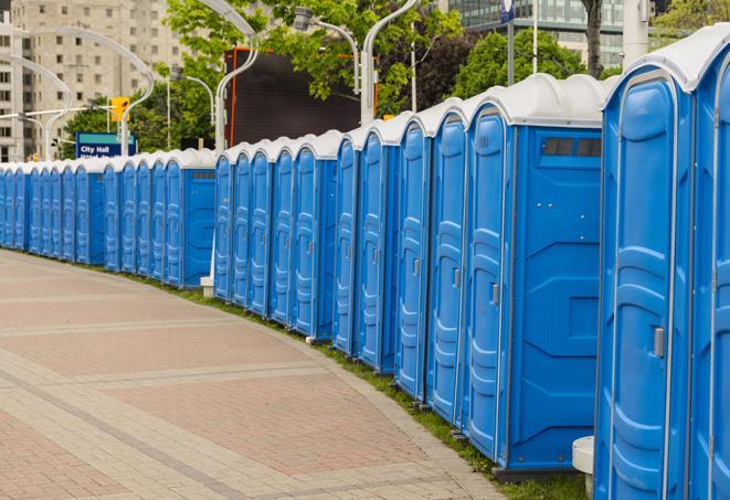 a line of portable restrooms at a sporting event, providing athletes and spectators with clean and accessible facilities in Andover CT